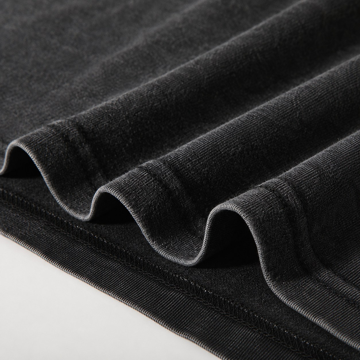 Washed cotton T-shirt hem and fabric detail